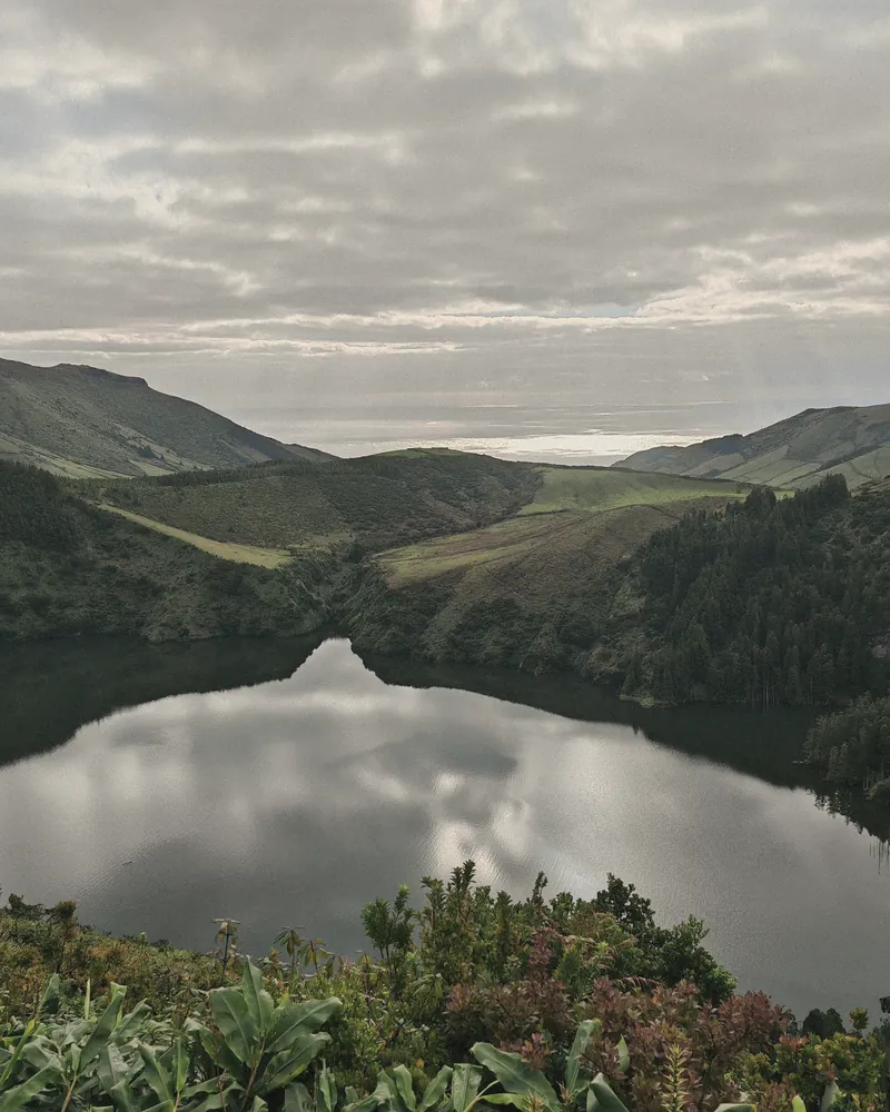 Still crater lake on Flores with clouds reflected in the water